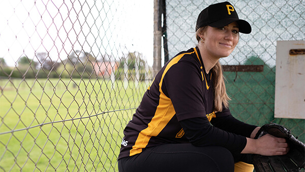 softball player sitting on the sideline